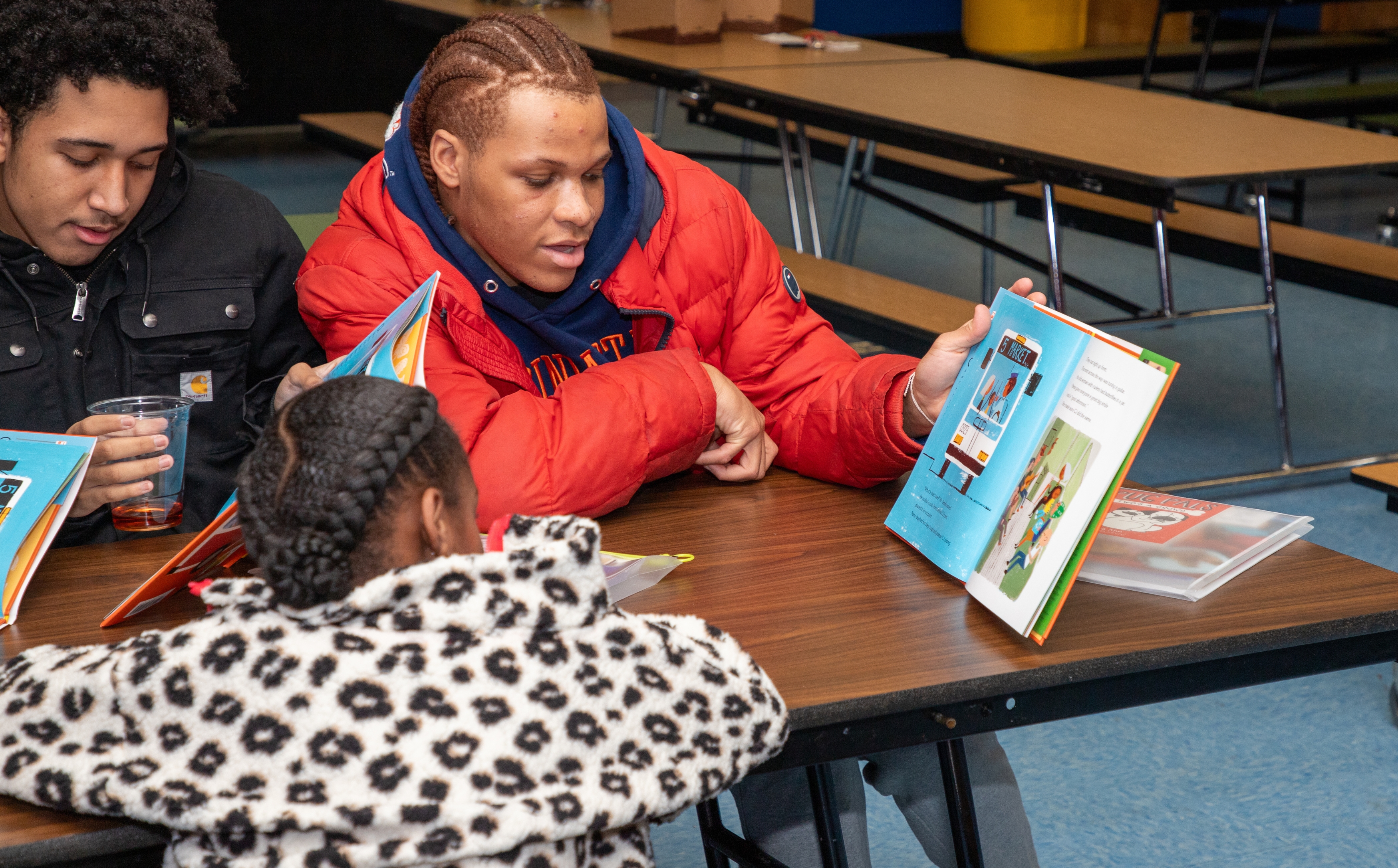 students showing each other the book