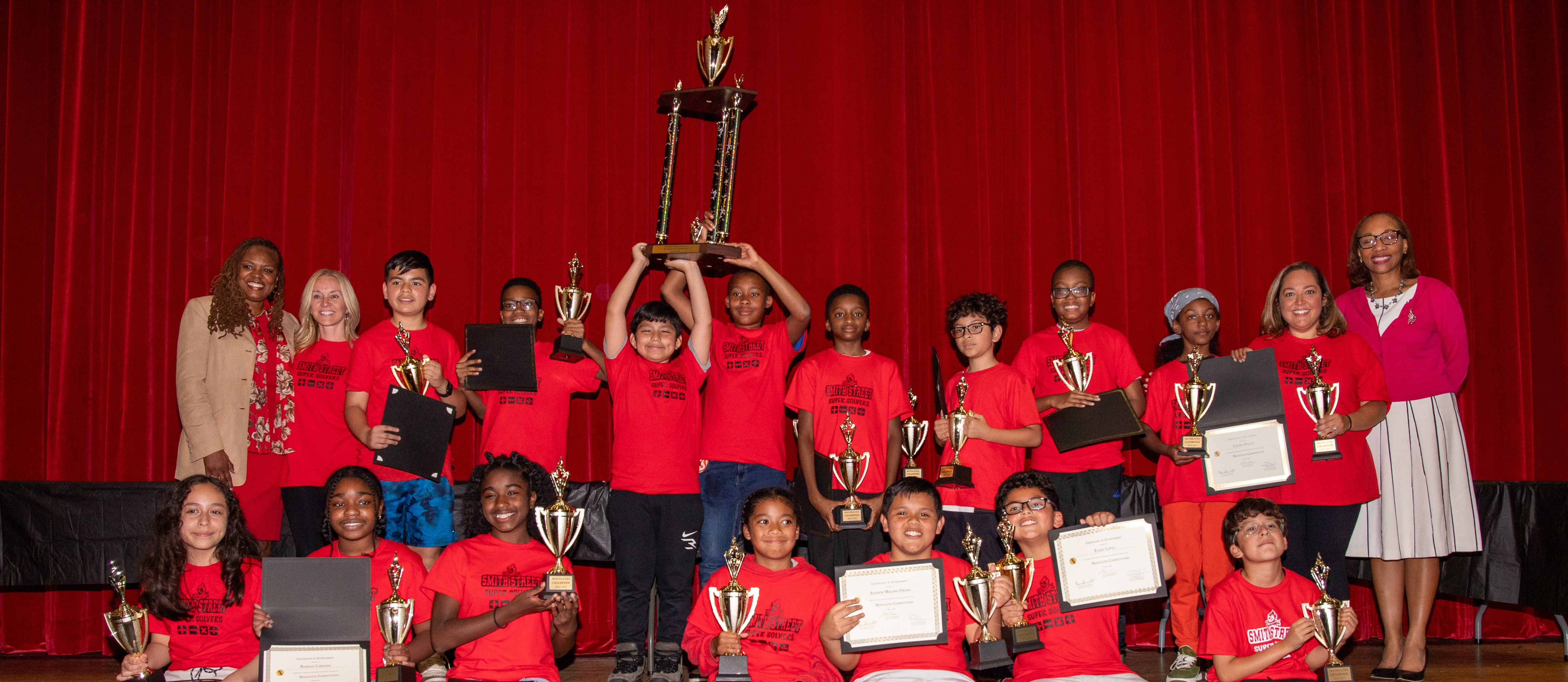 Students holding trophy
