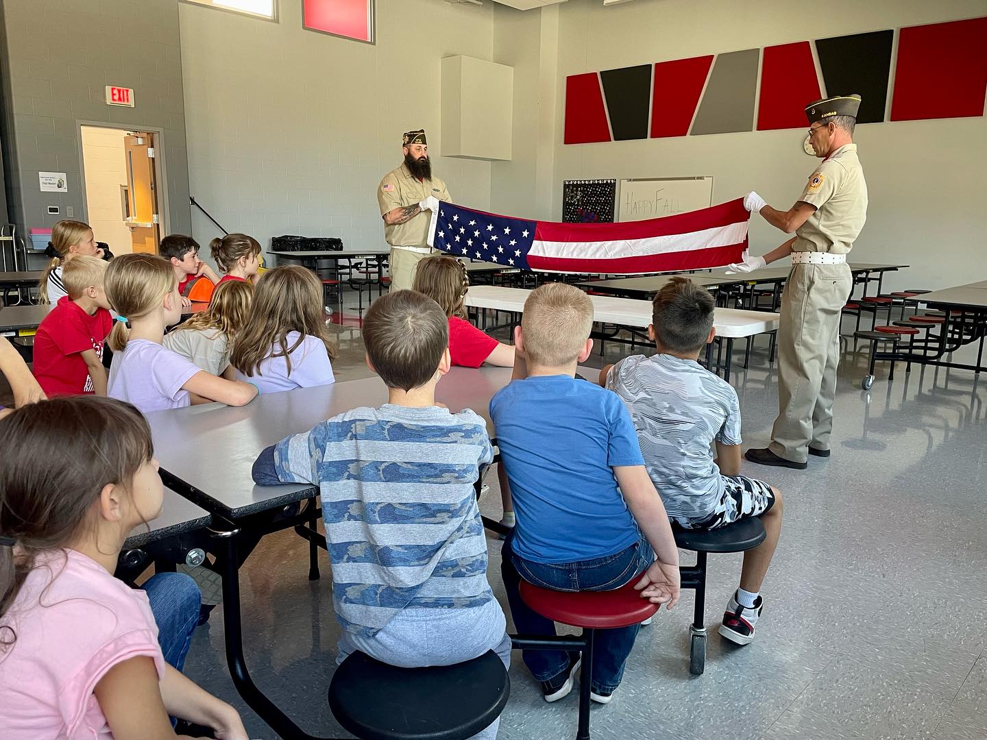 Students learning how to fold American Flag
