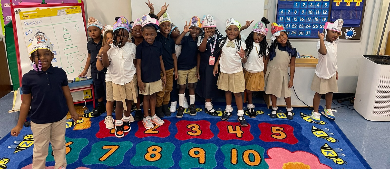 Students pose in a classroom