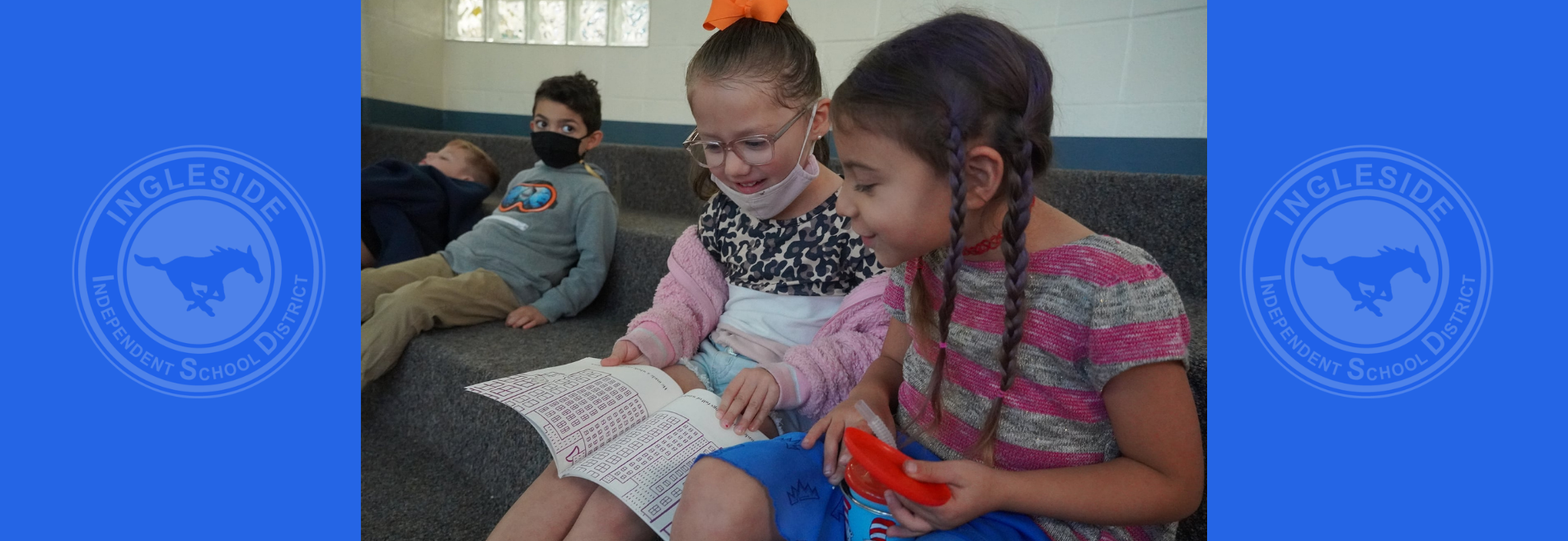 Girls reading a book during Read Across America Week