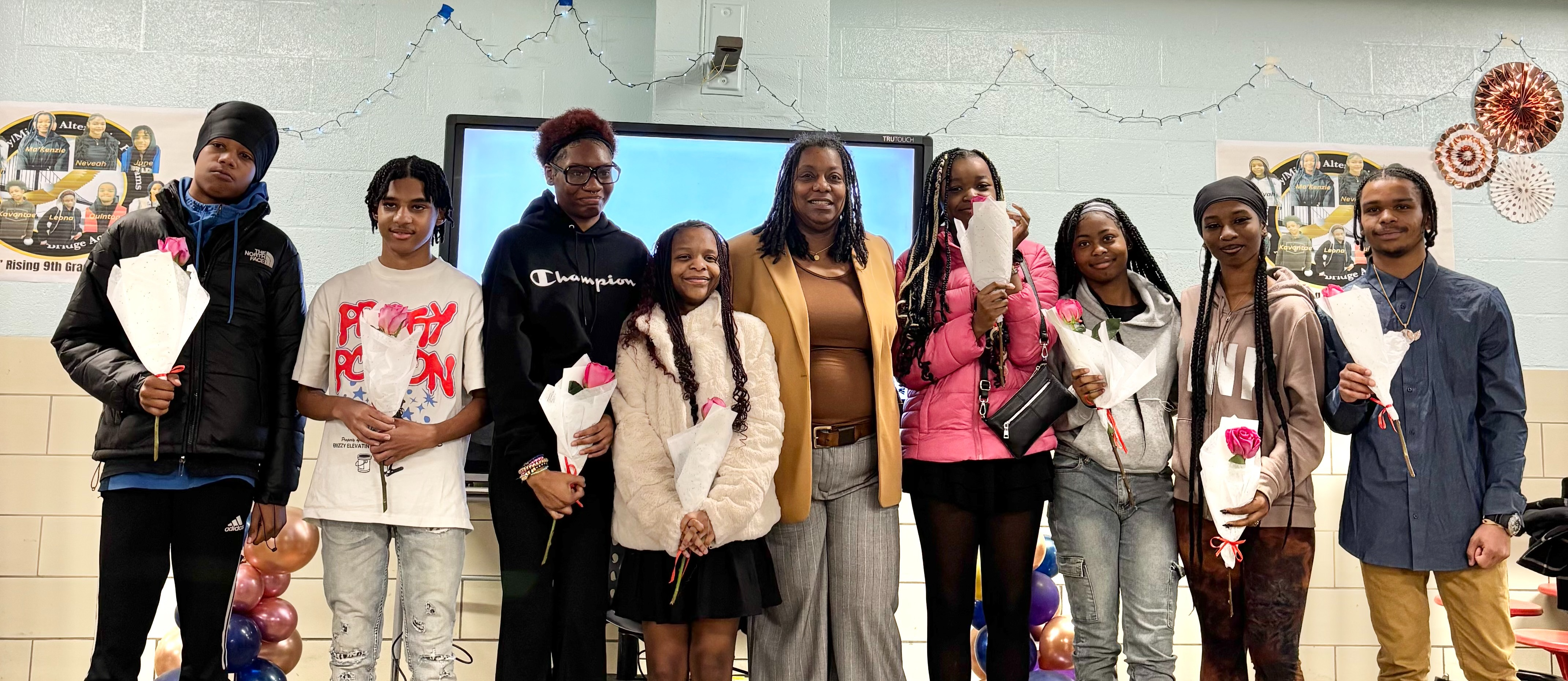 Principal and 8th grade students take graduation picture together