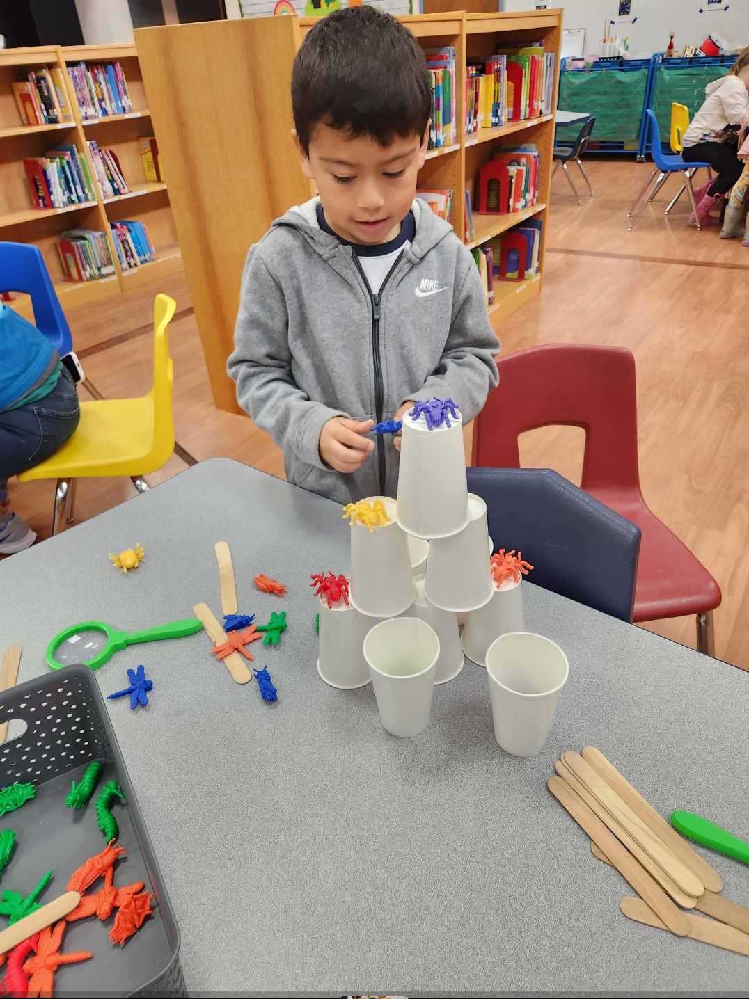 Little boy building a tower at camp