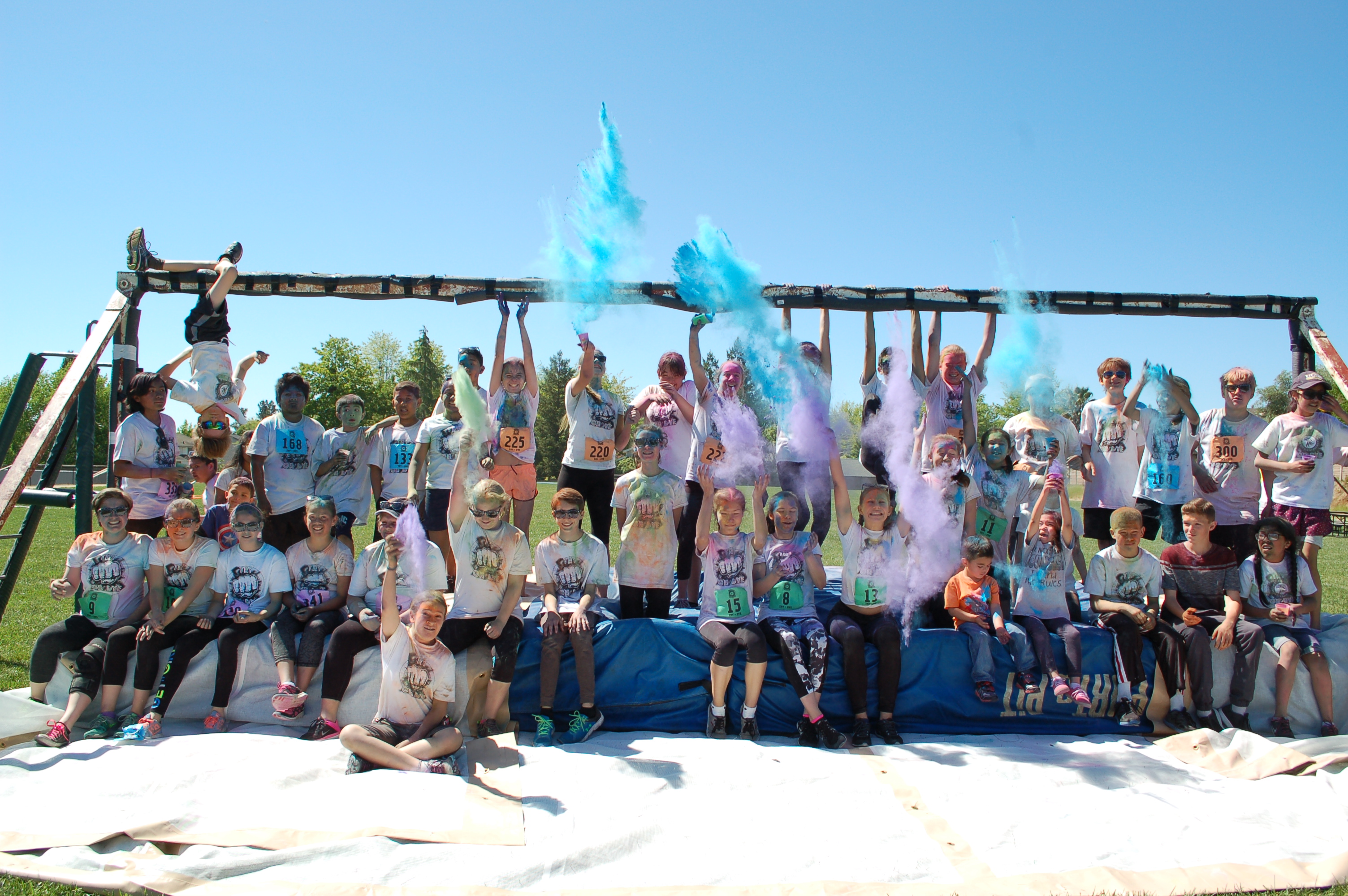 A photo of some students and staff playing with color powders.