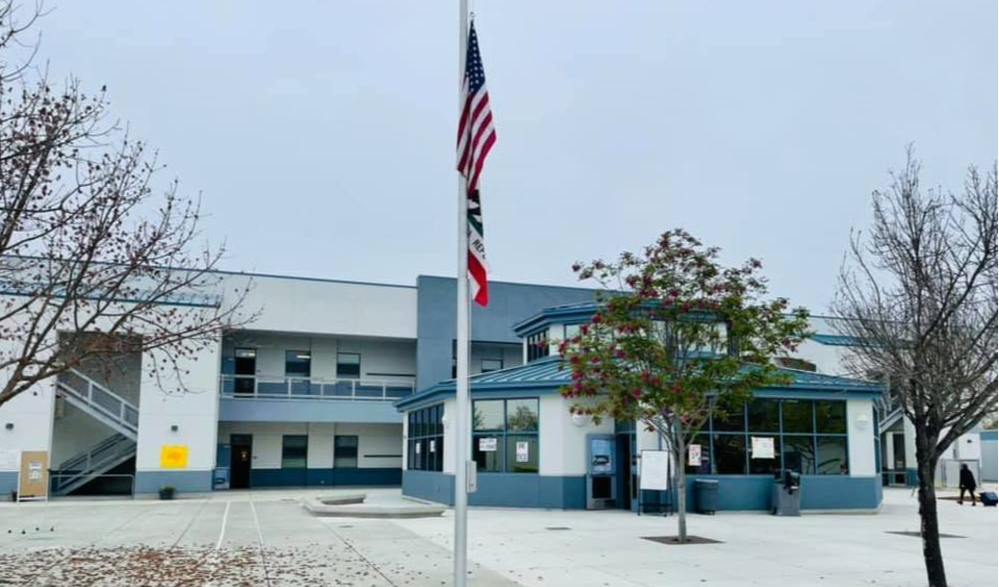 Flag pole in front of school building