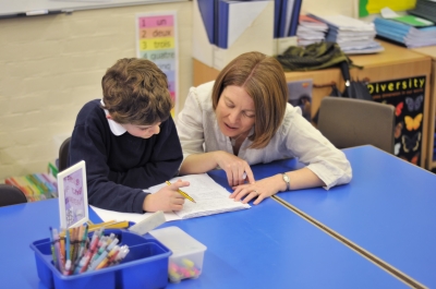 A photo of a volunteer helping a student.