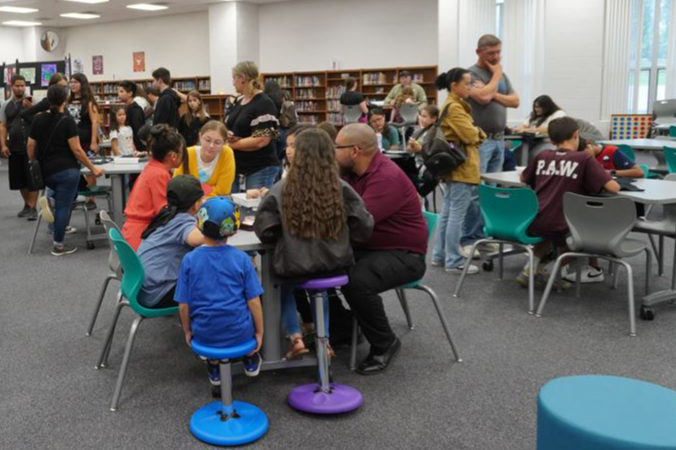 students and parents in library