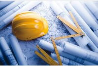 Yellow Hard hat and ruler sitting on construction plans
