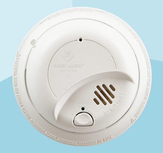White smoke detector on two-toned blue background