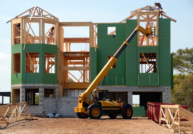 A 3-story wood frame building under construction 