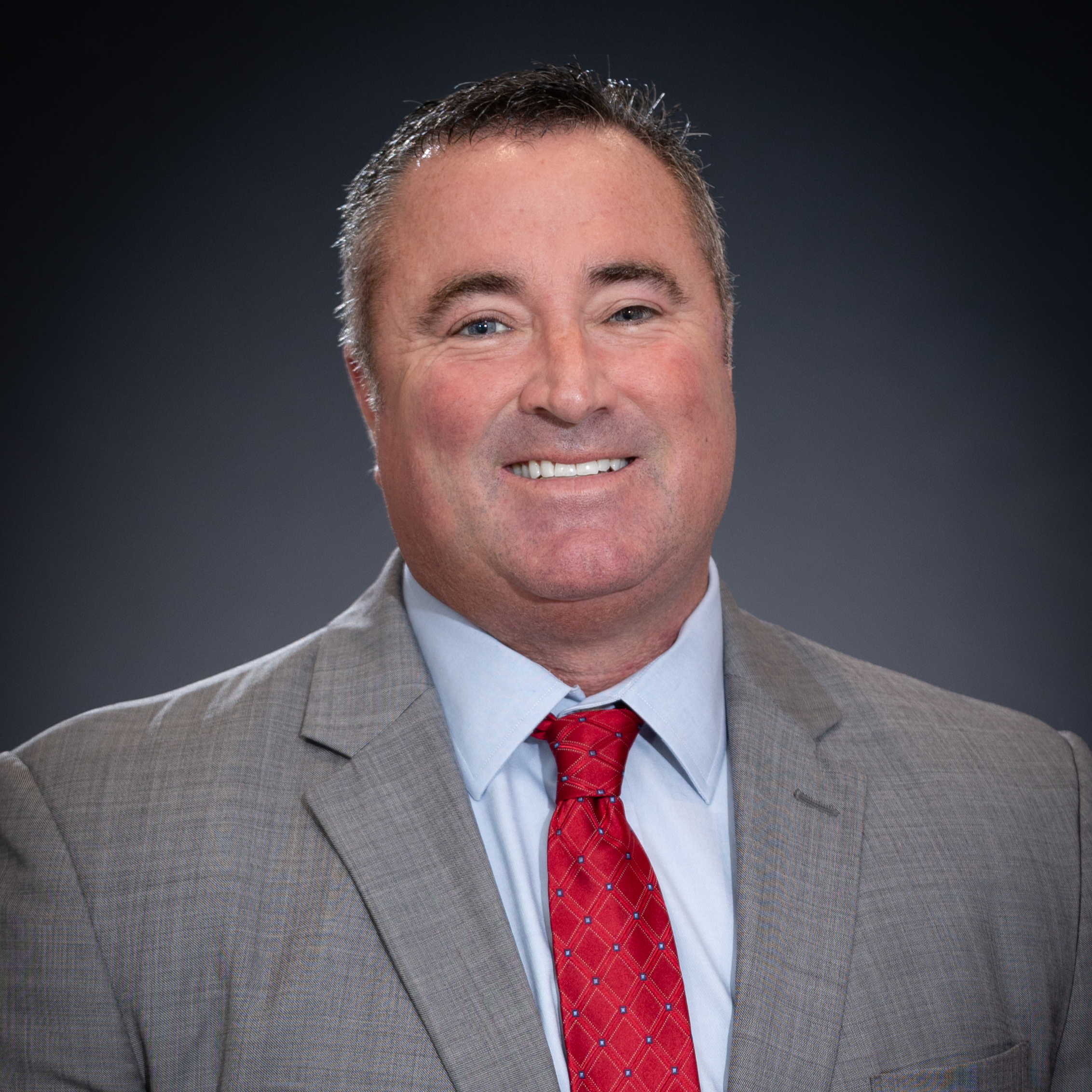 Headshot of Mayor Mike Wissman in light gray suit with red tie