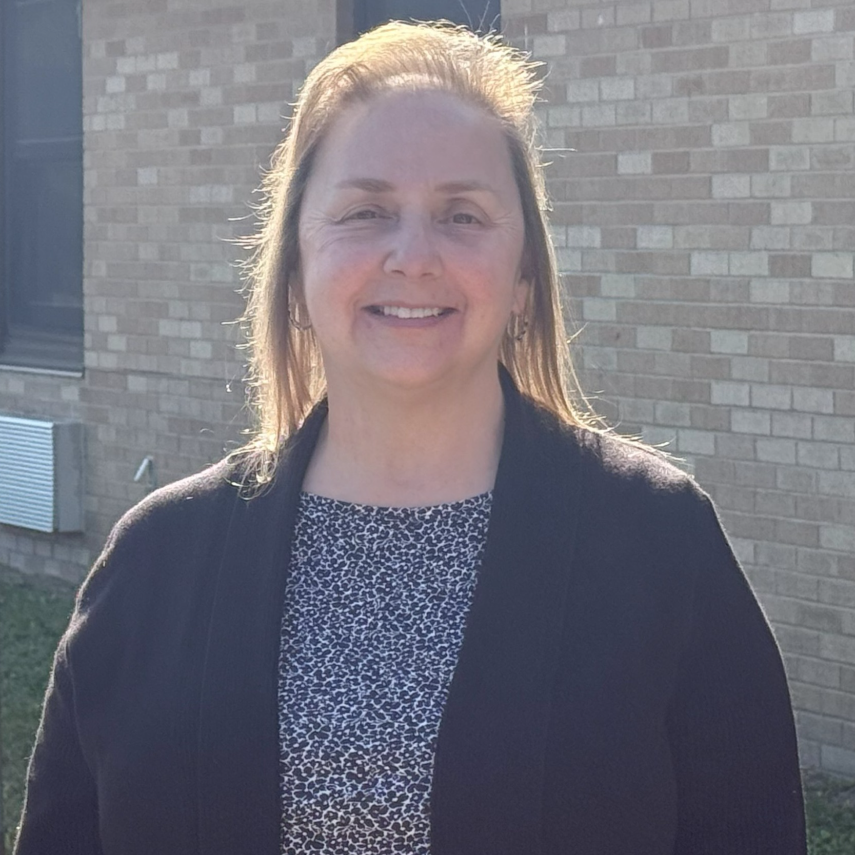 teacher in front of building