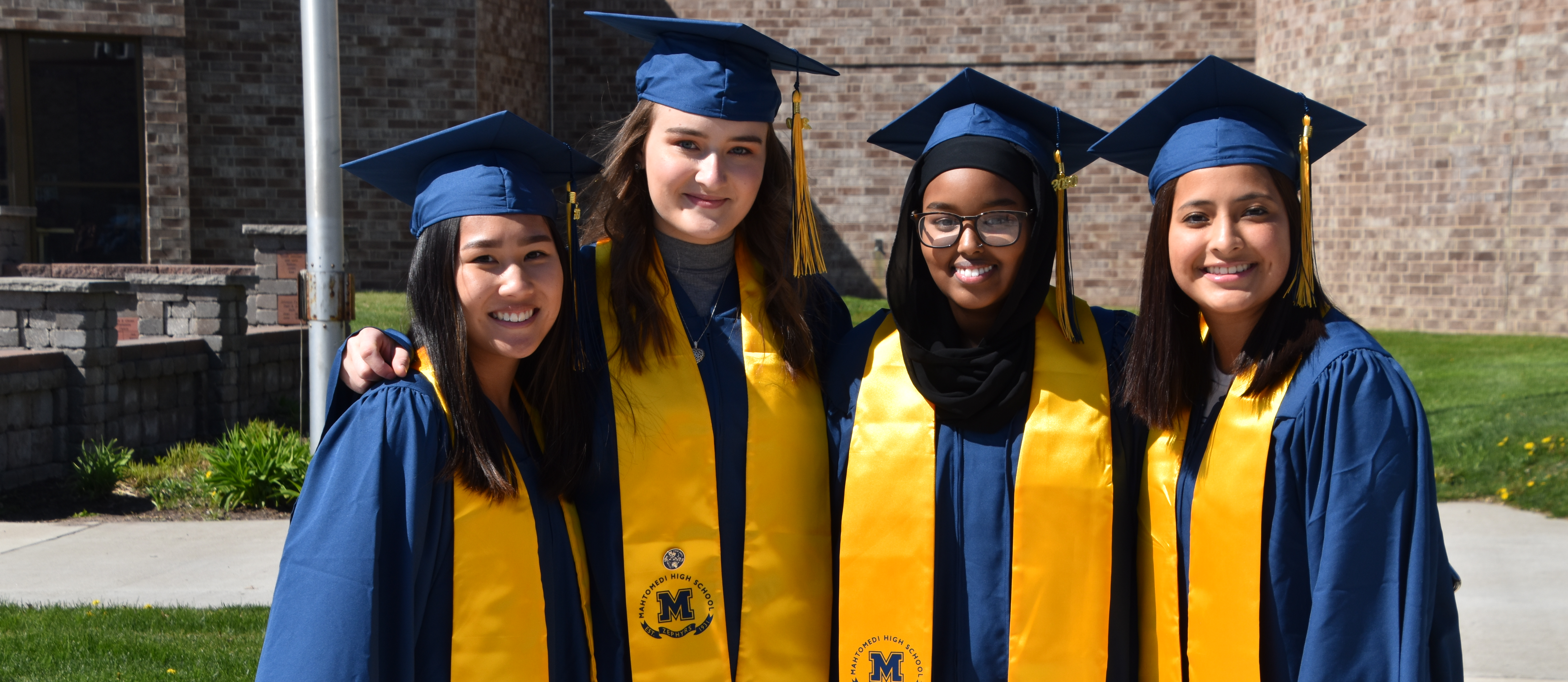 Four graduates standing together