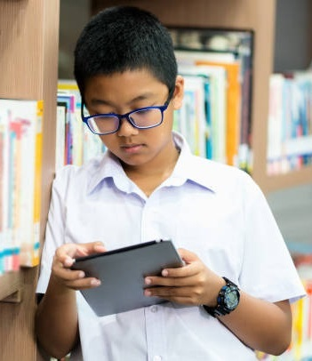 Student searching for books on a tablet