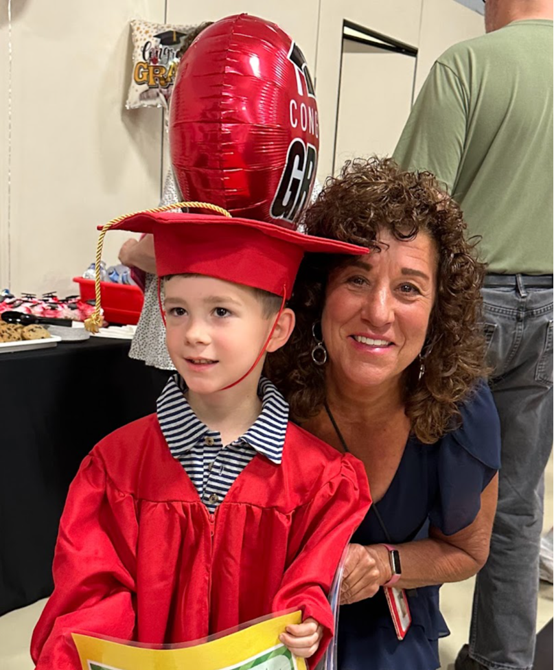 Miss Debbie with another smart preschool grad in cap & gown