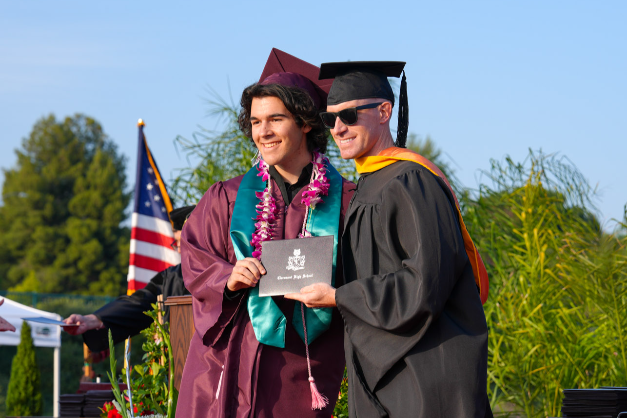 A CHS student taking a picture with his teacher and diploma at the 2023 Graduation Ceremony.
