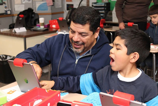 Man and boy using iPad