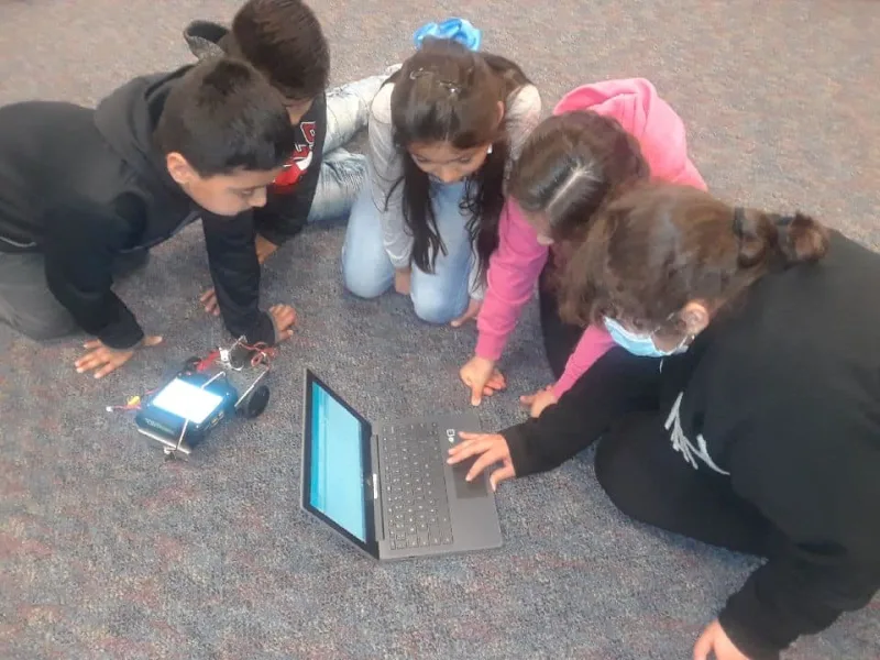 Kids looking at laptop