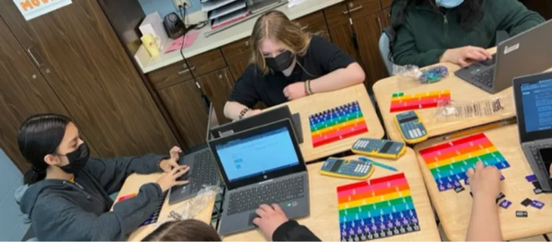 Students with laptops in class