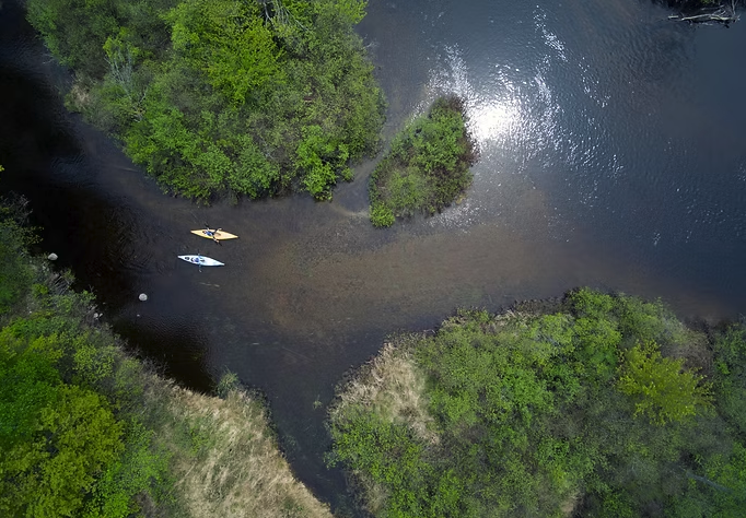 two kayaks in millinocket stream from above