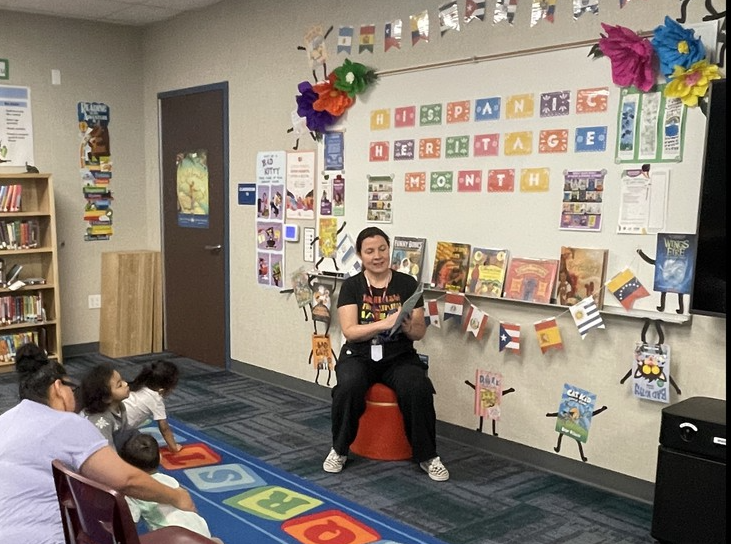 Miss Annie reading to a class in the library