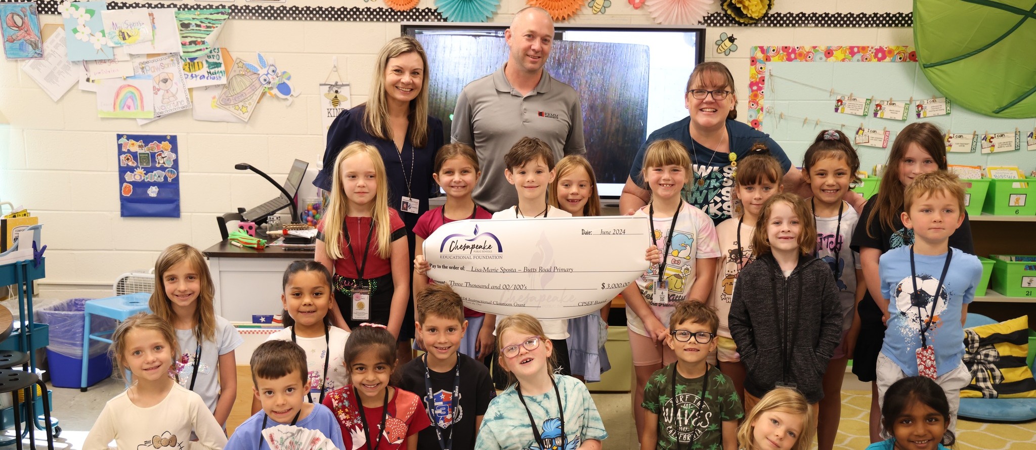 Teacher awarded a grant check at school