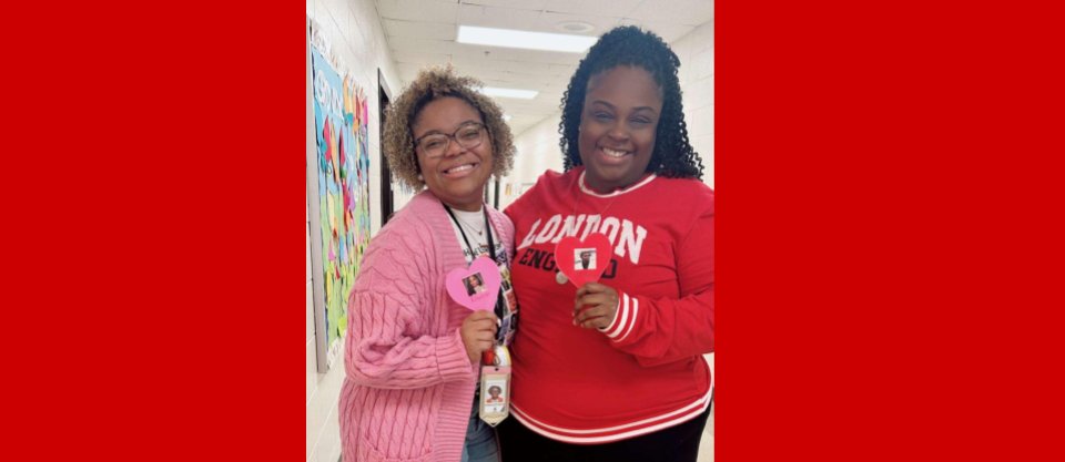 2 ladies holding paper hearts