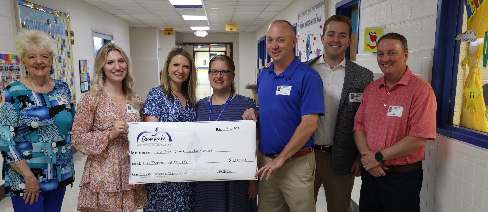 Teacher awarded a grant check at school