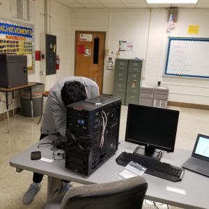 student fixing a computer