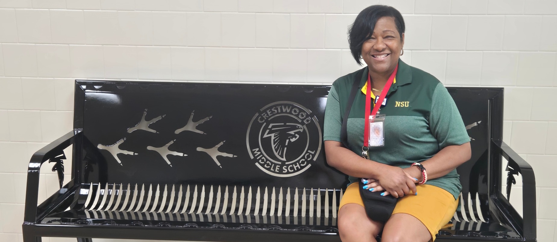Principal Ferebee sits on a new bench made by CCC welding students!