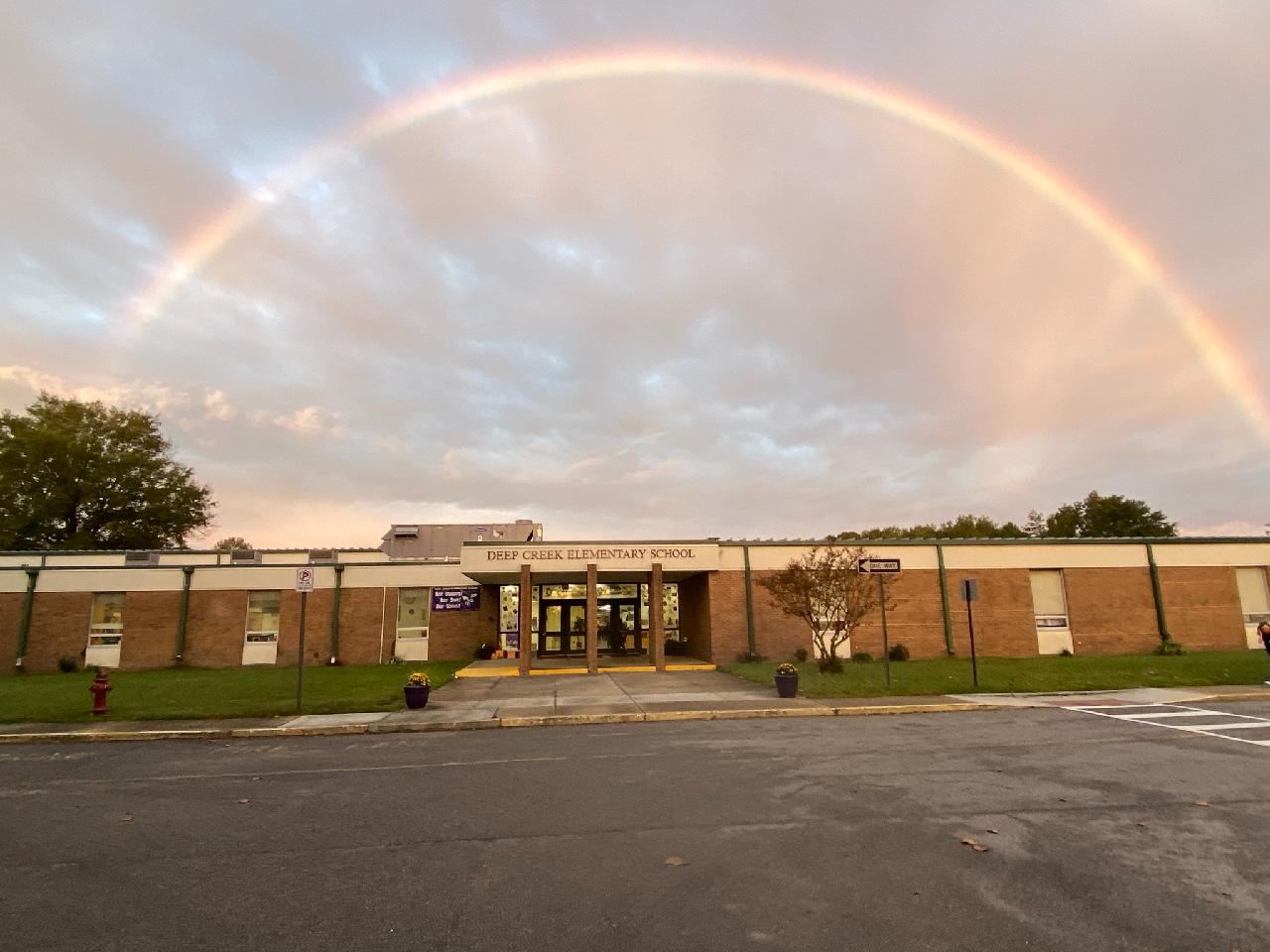 DCE with rainbow above school