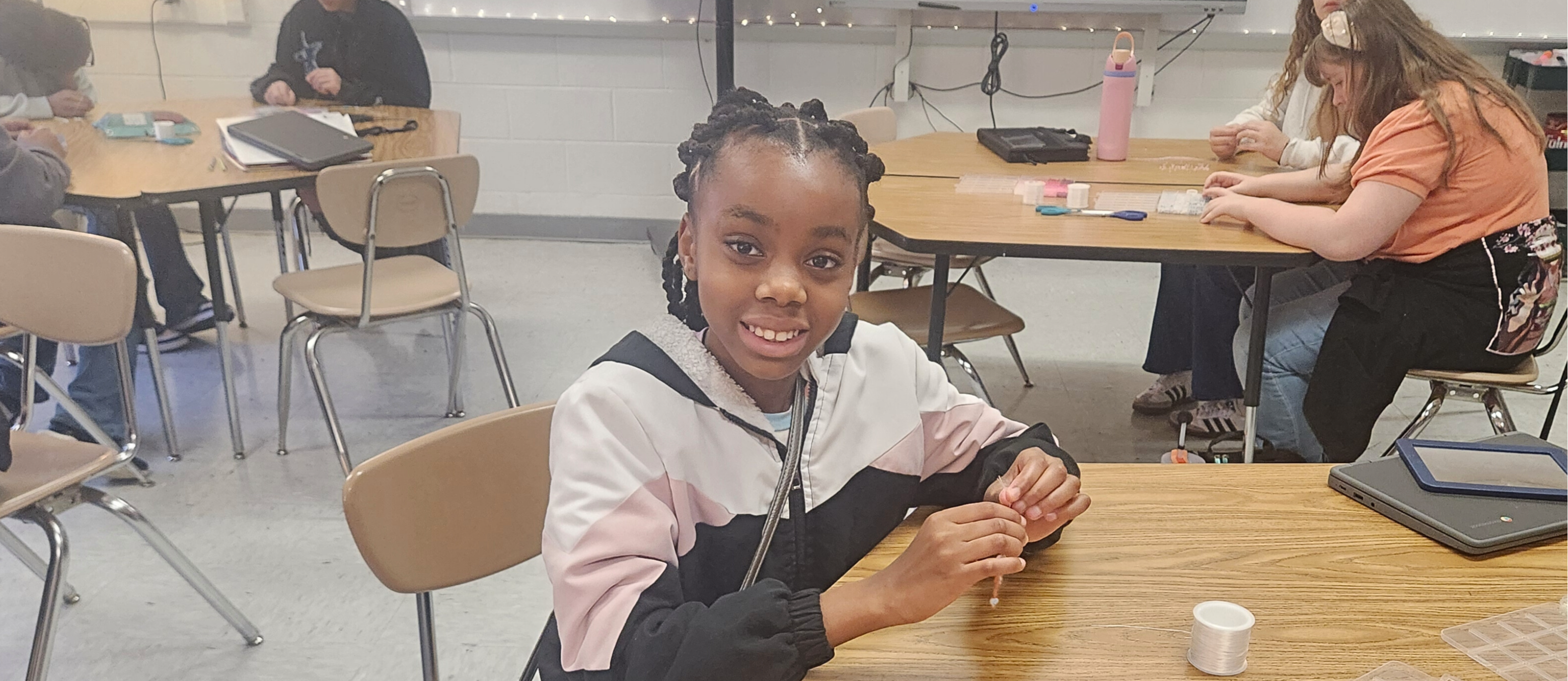 Student smiling at the bracelet club