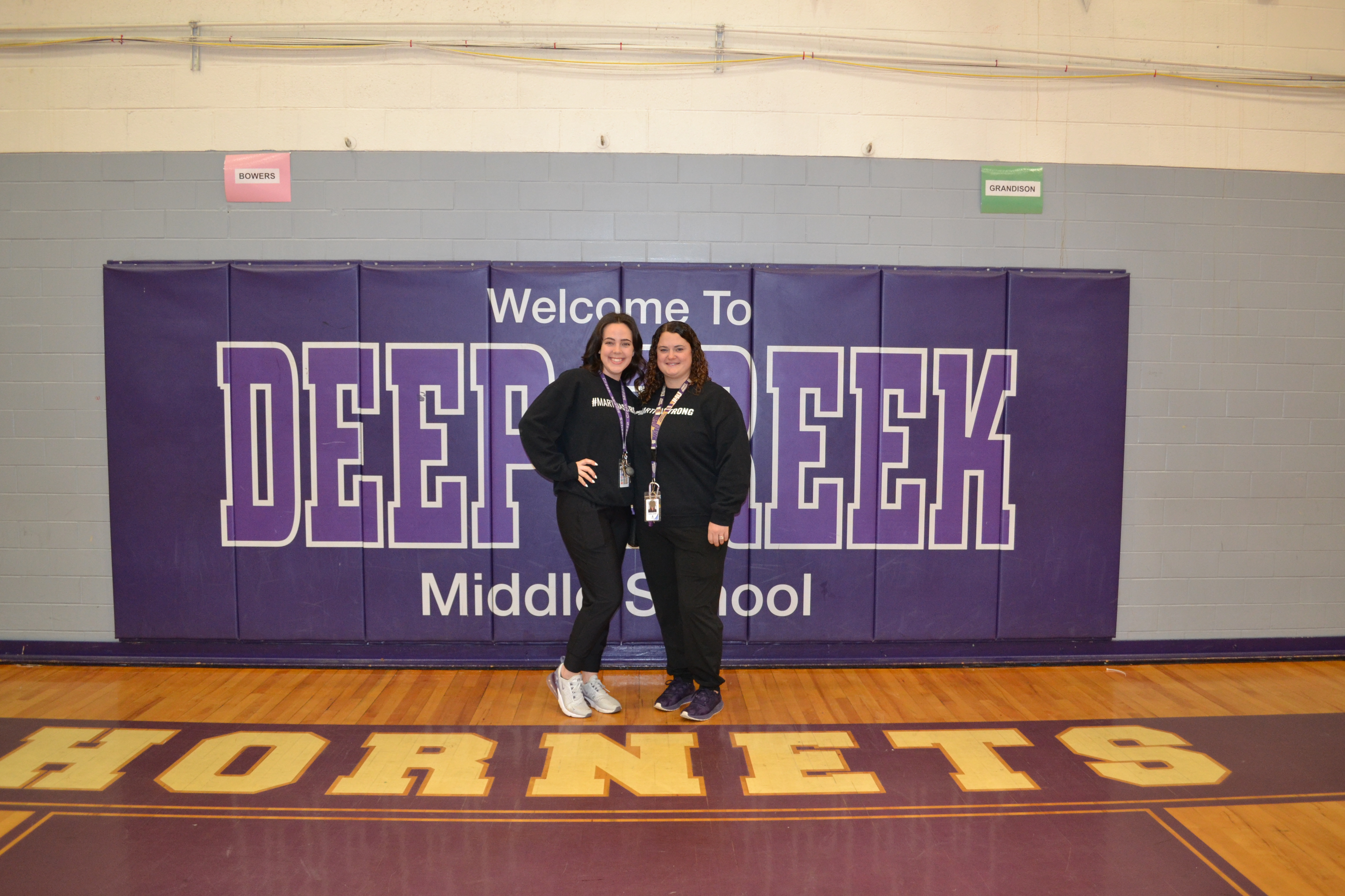 Our PE teacher standing in front of our DCMS sign for TWin Day