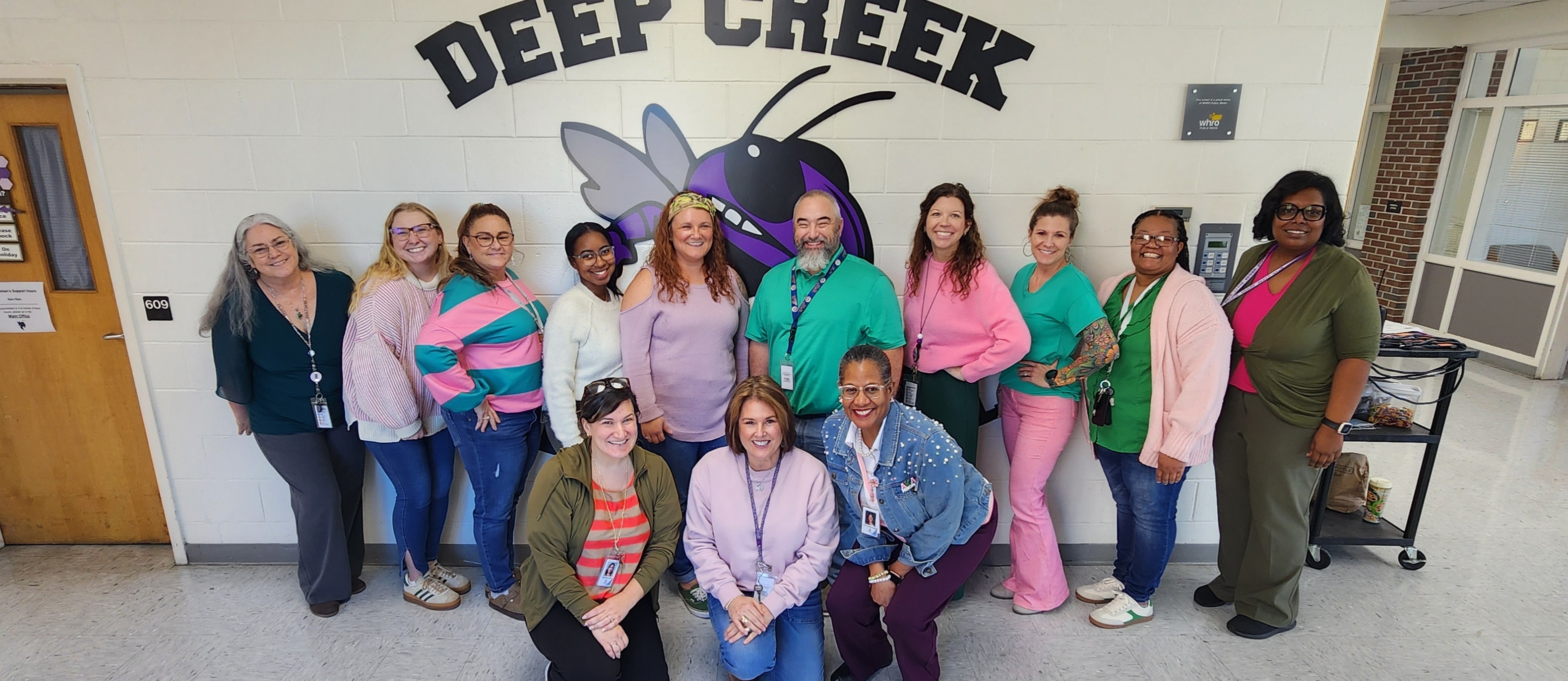 All of our seventh grade teachers wearing their pink and green!