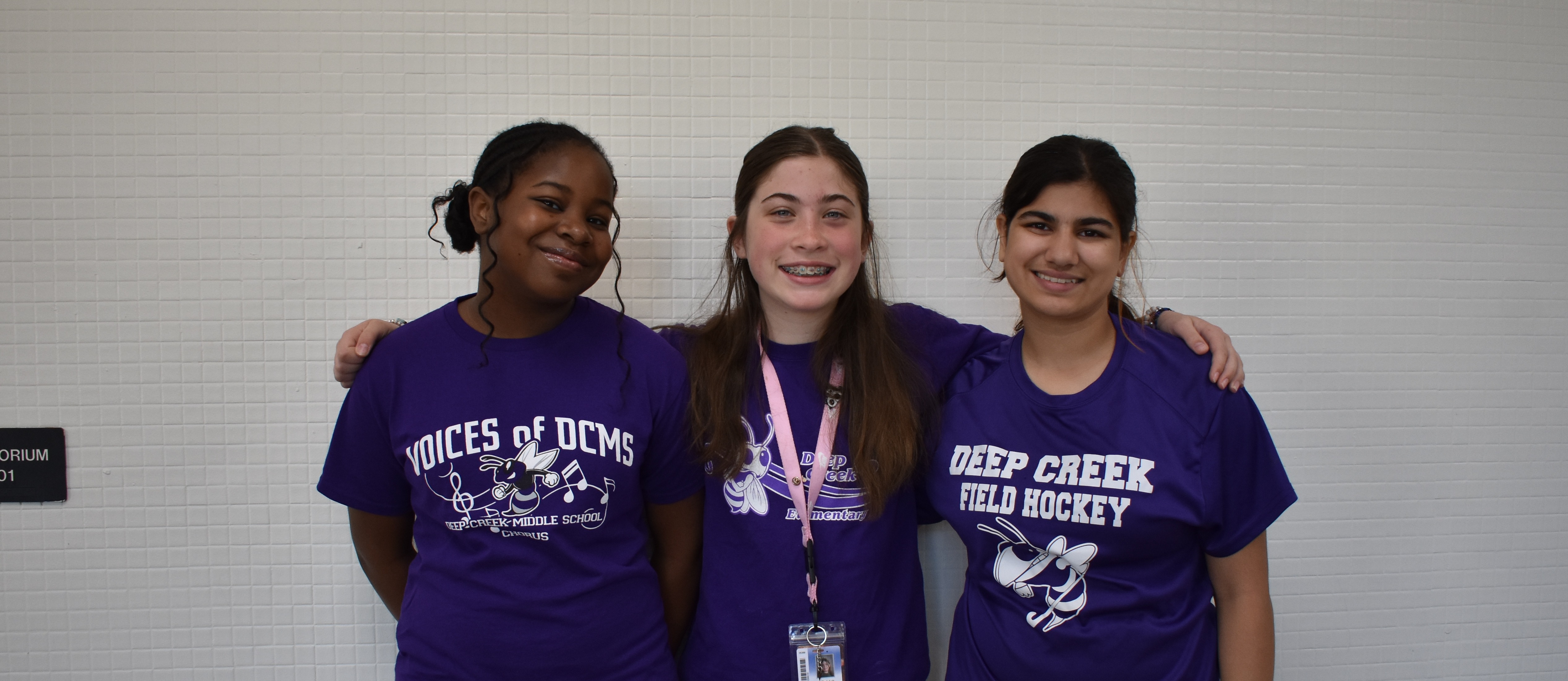 Three students wearing their purple to celebrate the Month of the Military Family.