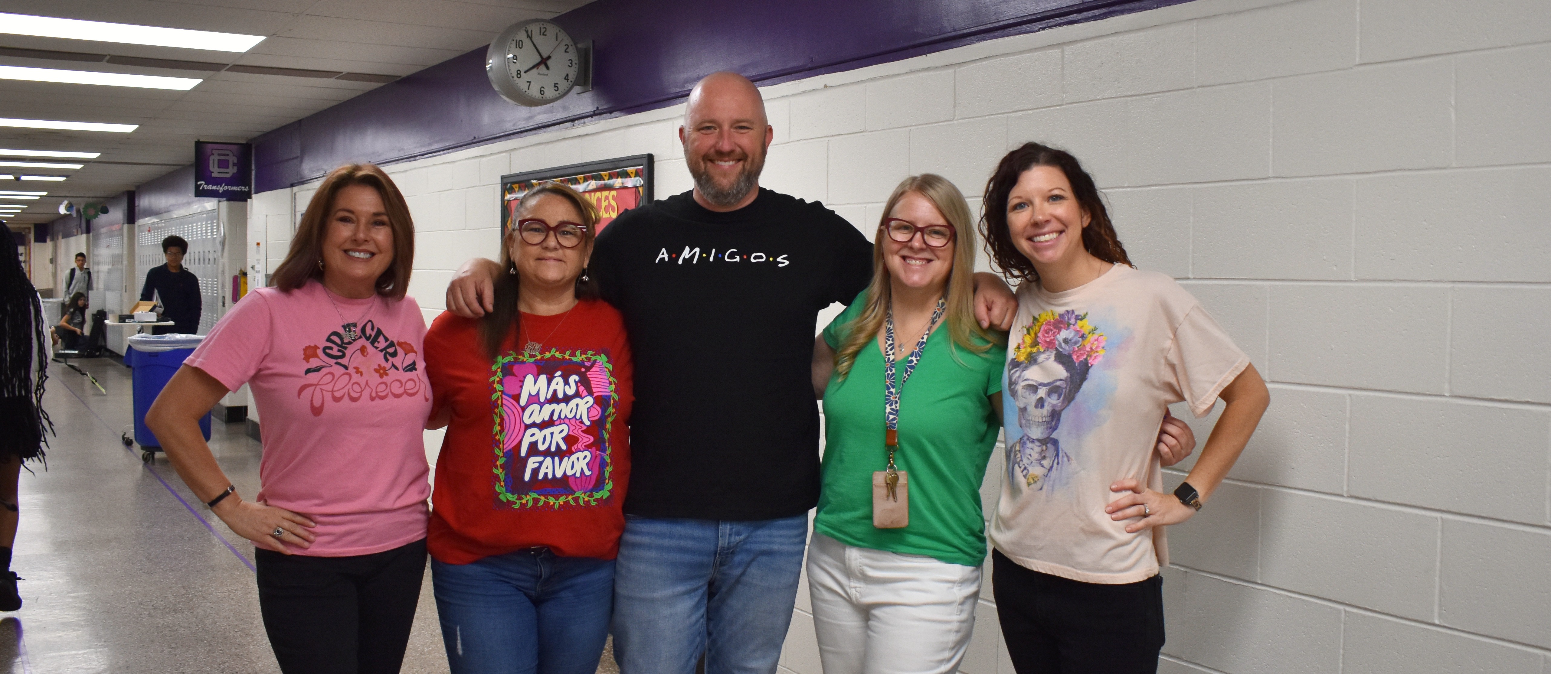 A group of teacher wearing a the colors of the Mexican flag to celebrate Cinco De mayo