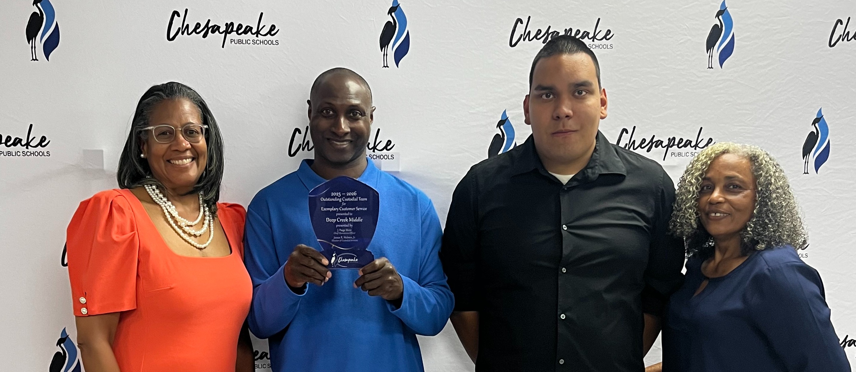 Our custodians and principal posing for their award!