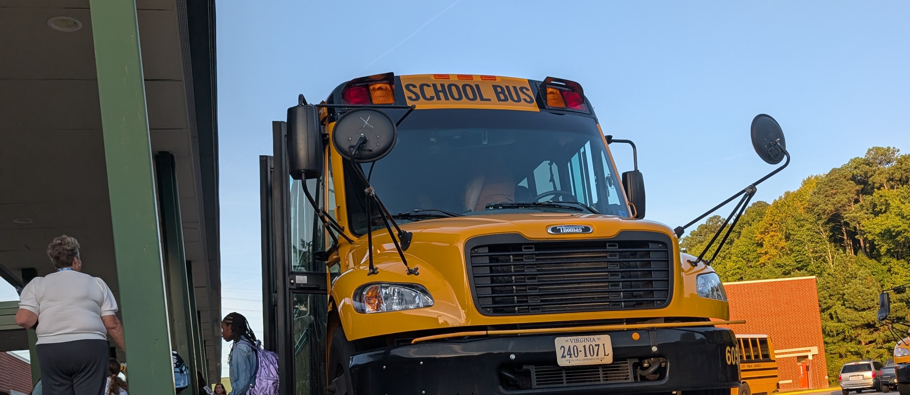 First day of school bus drop off on the bus ramp. Students getting off the bus.