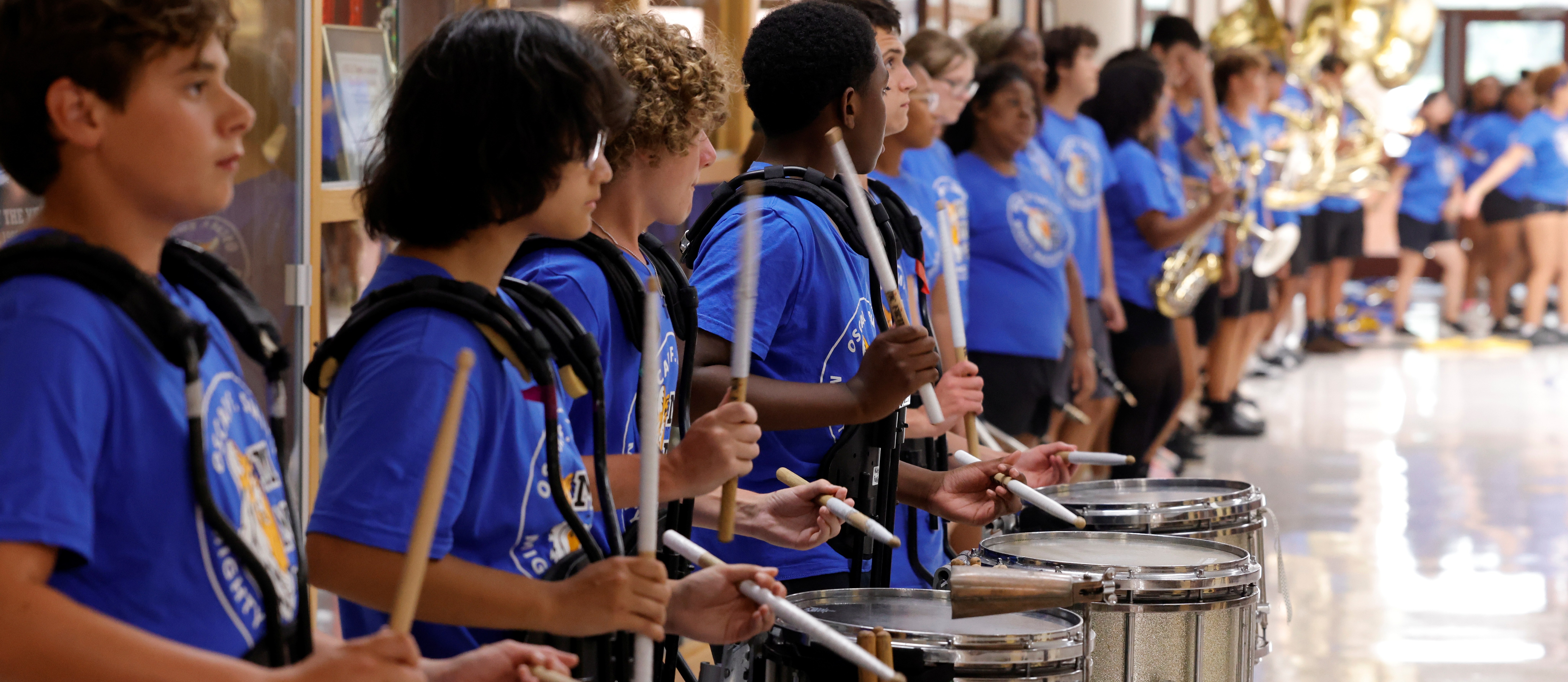 The OSH Drumline plays a cadence