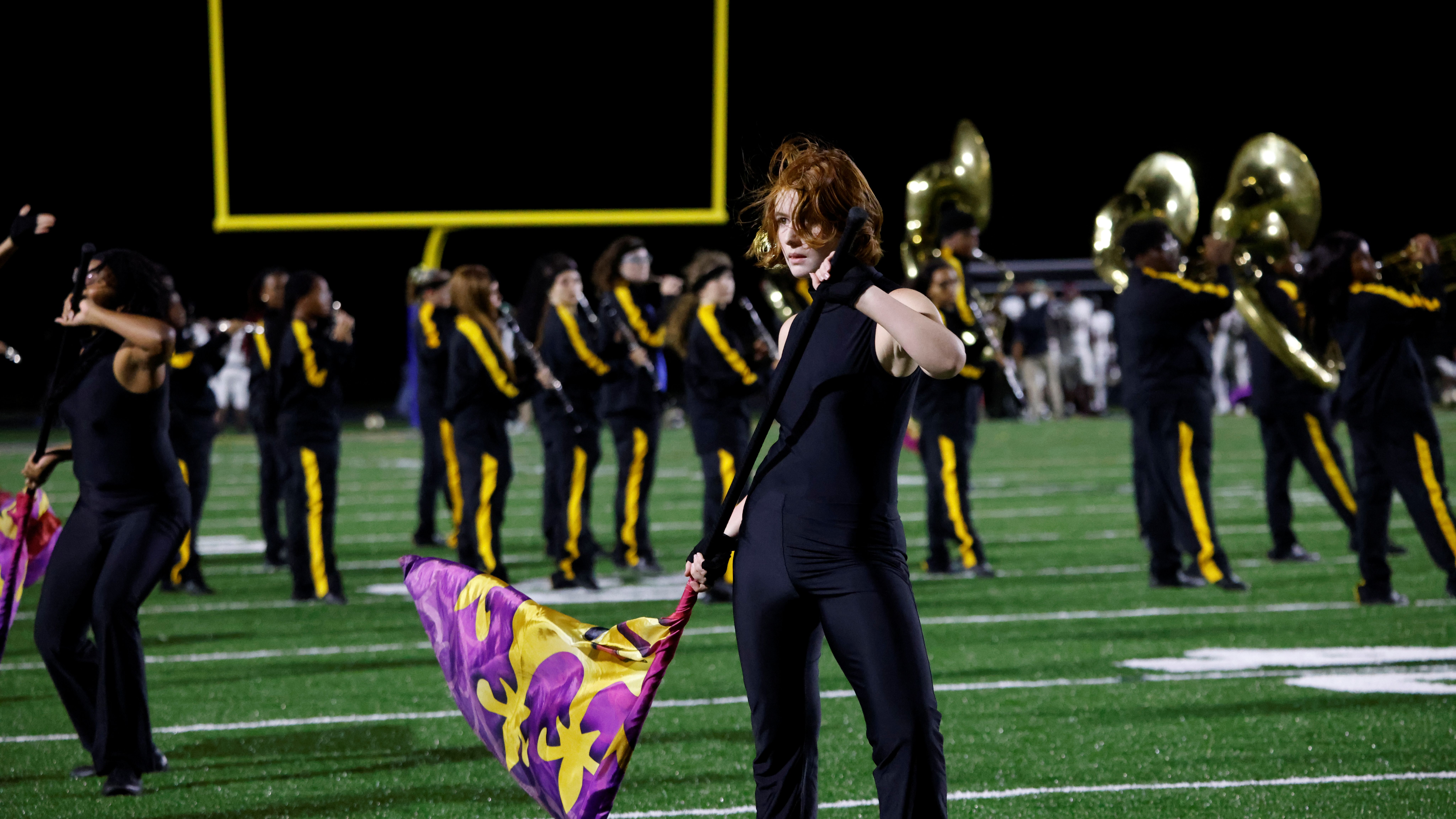 A member of the OSHS color guard performs her routine during a halftime performance