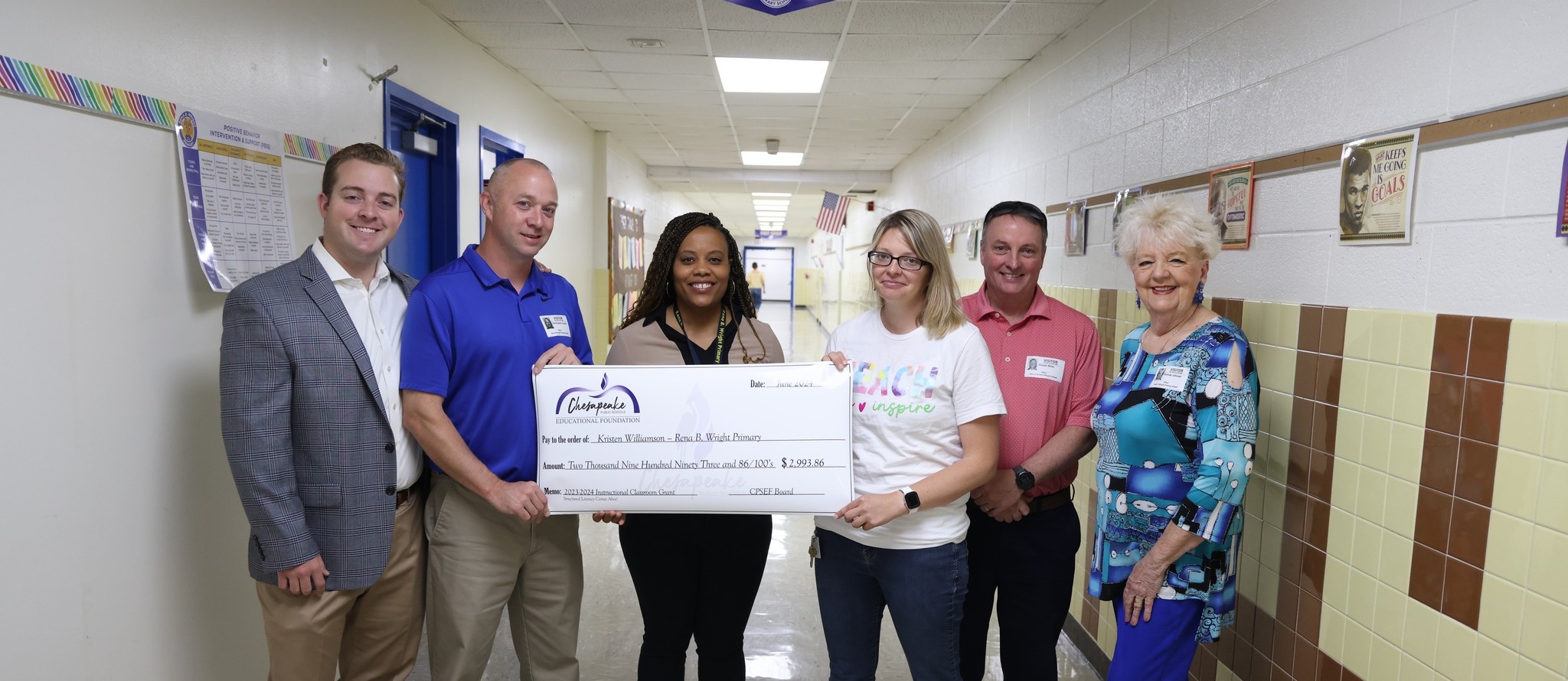 Teacher awarded a grant check at school
