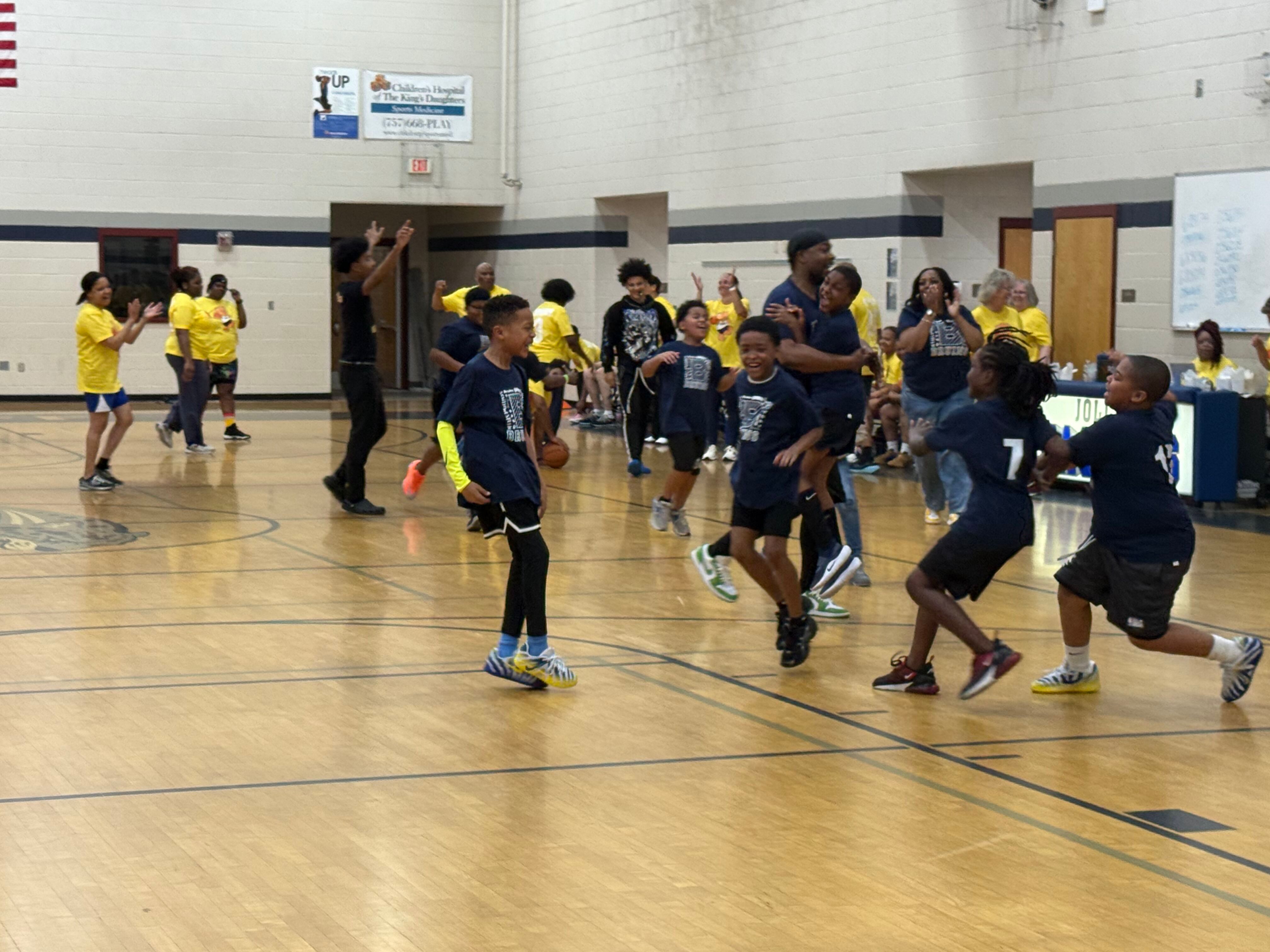 students playing at the staff vs student basketball game