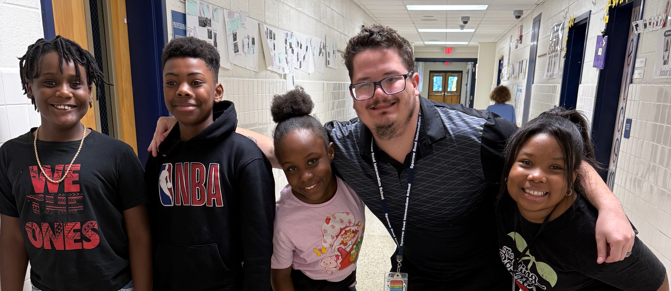 Hepner and students in hallway