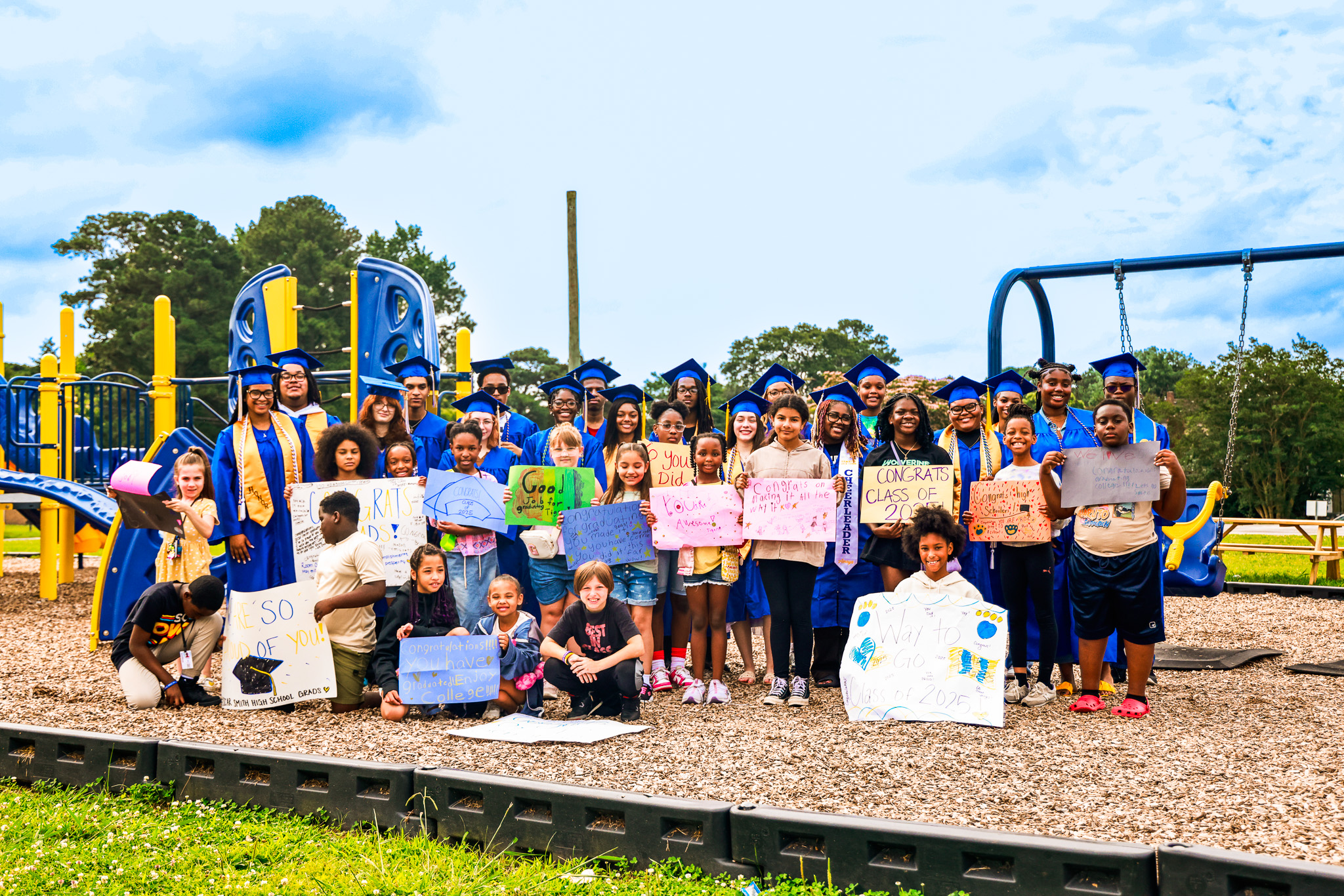 Members of the OSHS Class of 2025 and Truitt Alumni take a picture with members of the TIS third grade 