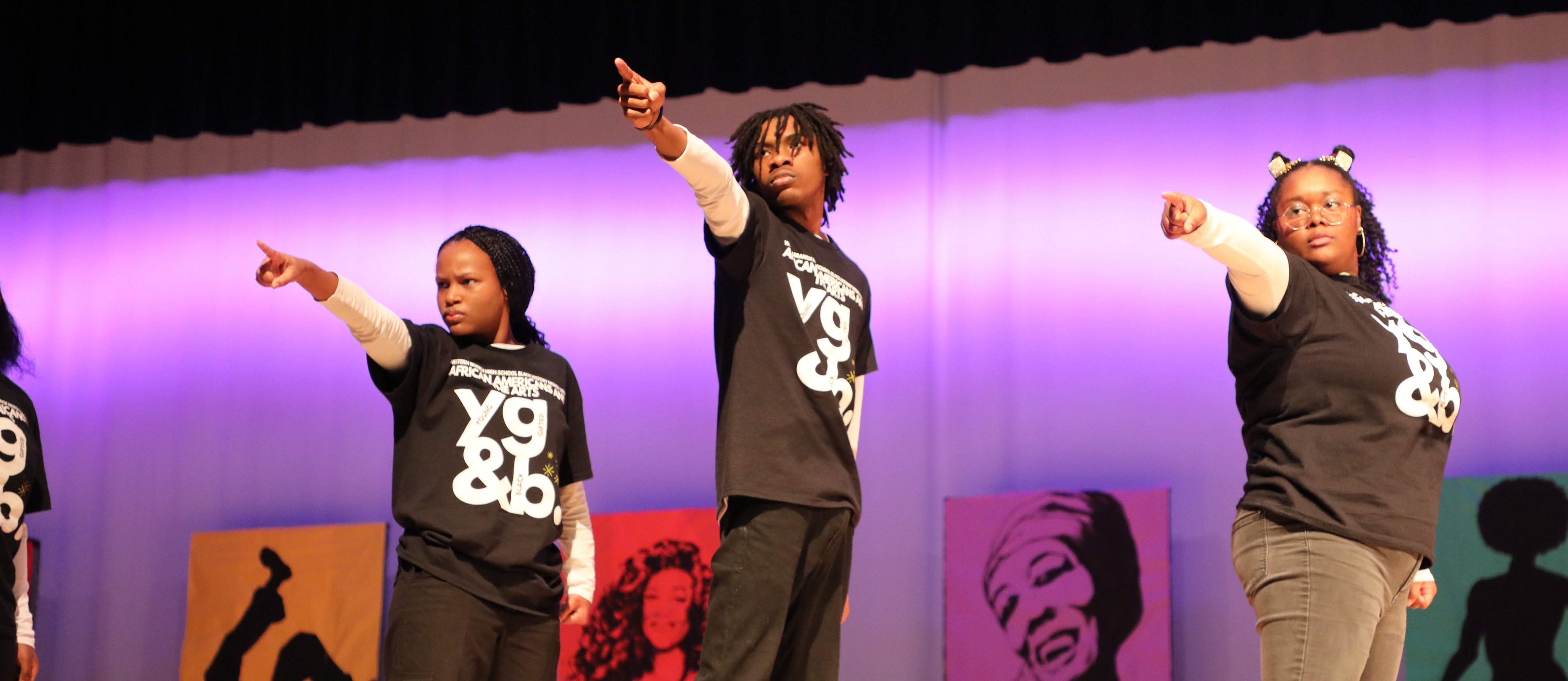Student performers at the 2024 BHM program point to the crowd.