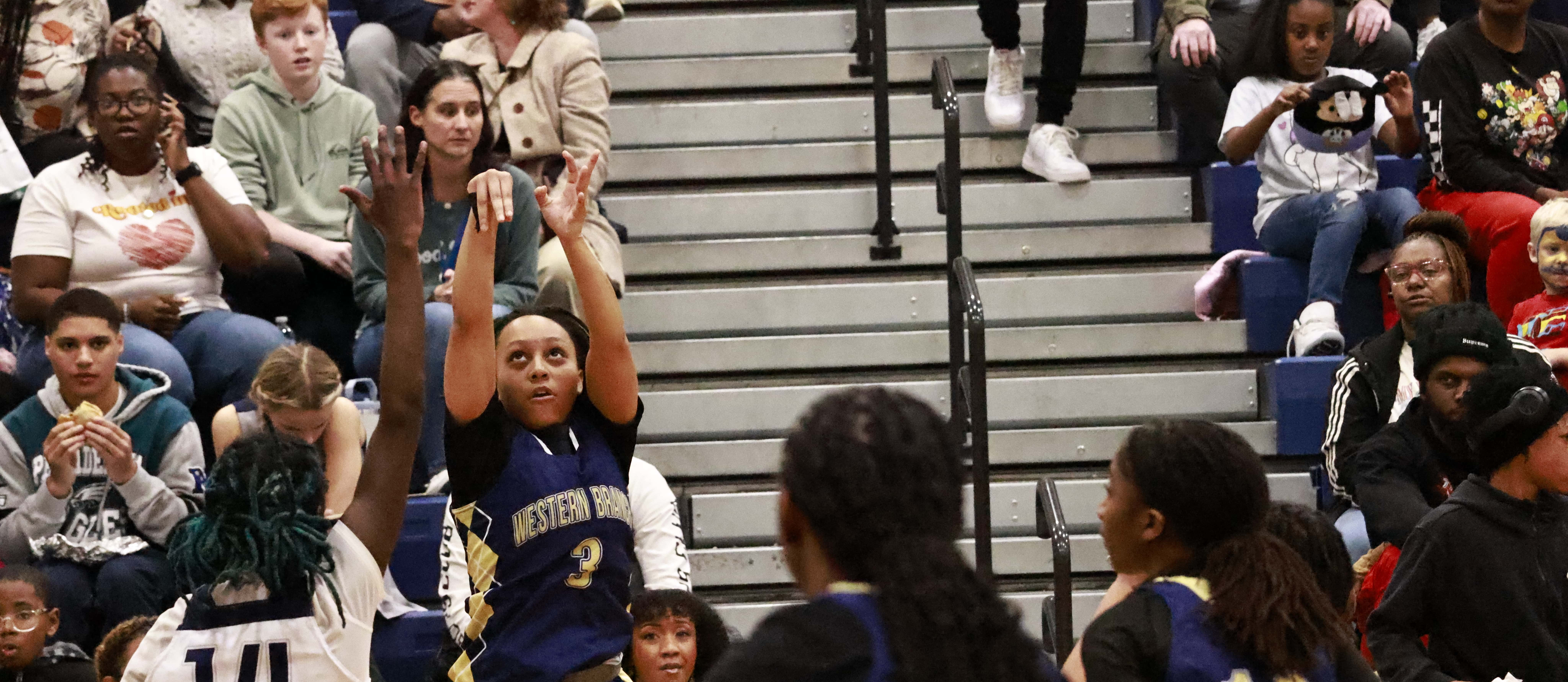 WBM player shoots a shot in her basketball game