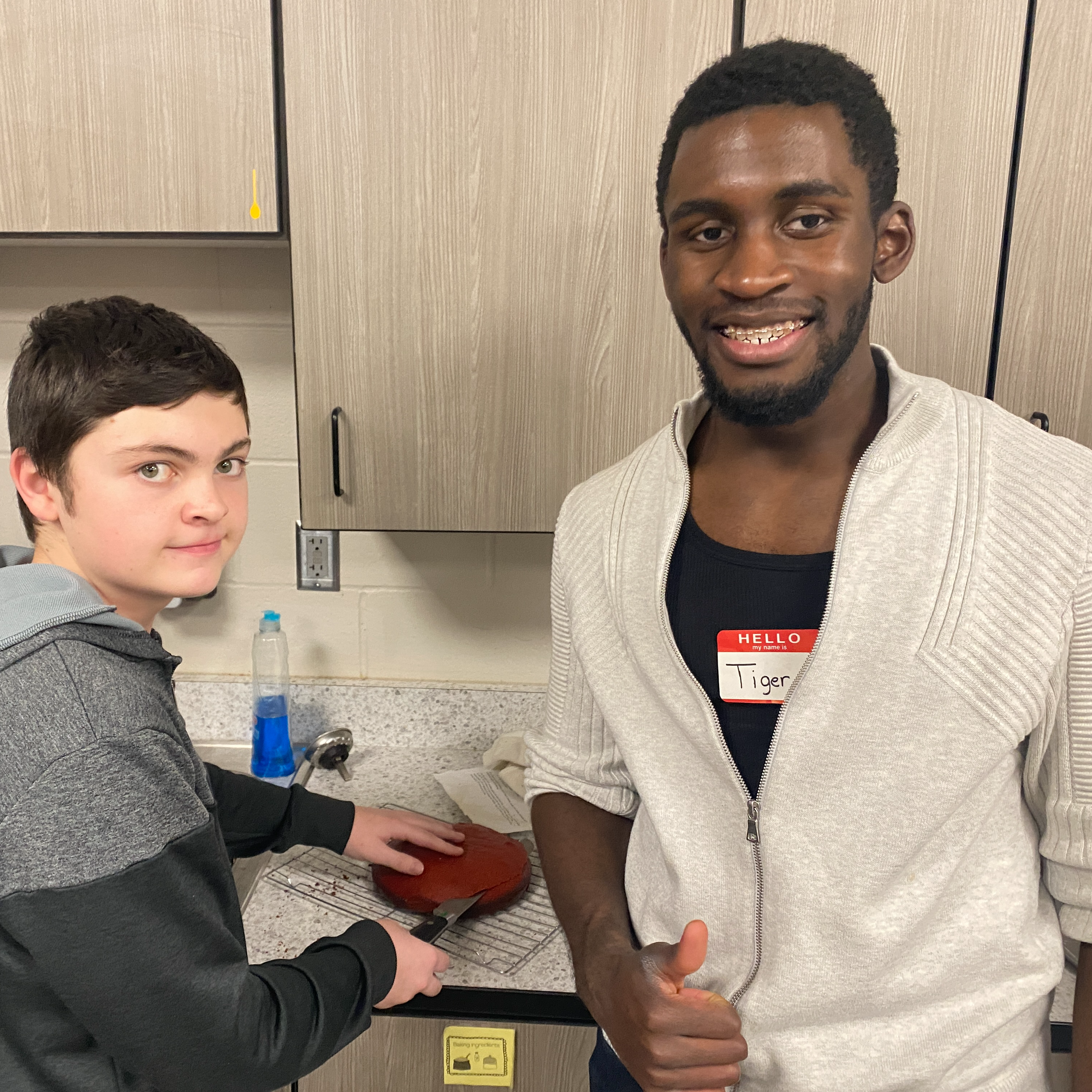 Tiger, an MHS mentor works with a middle school student at the cooking club