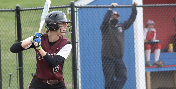 girl focused to hit the ball with the bat