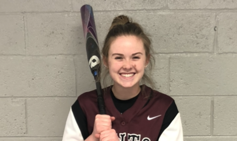 student softball headshot holding a bat