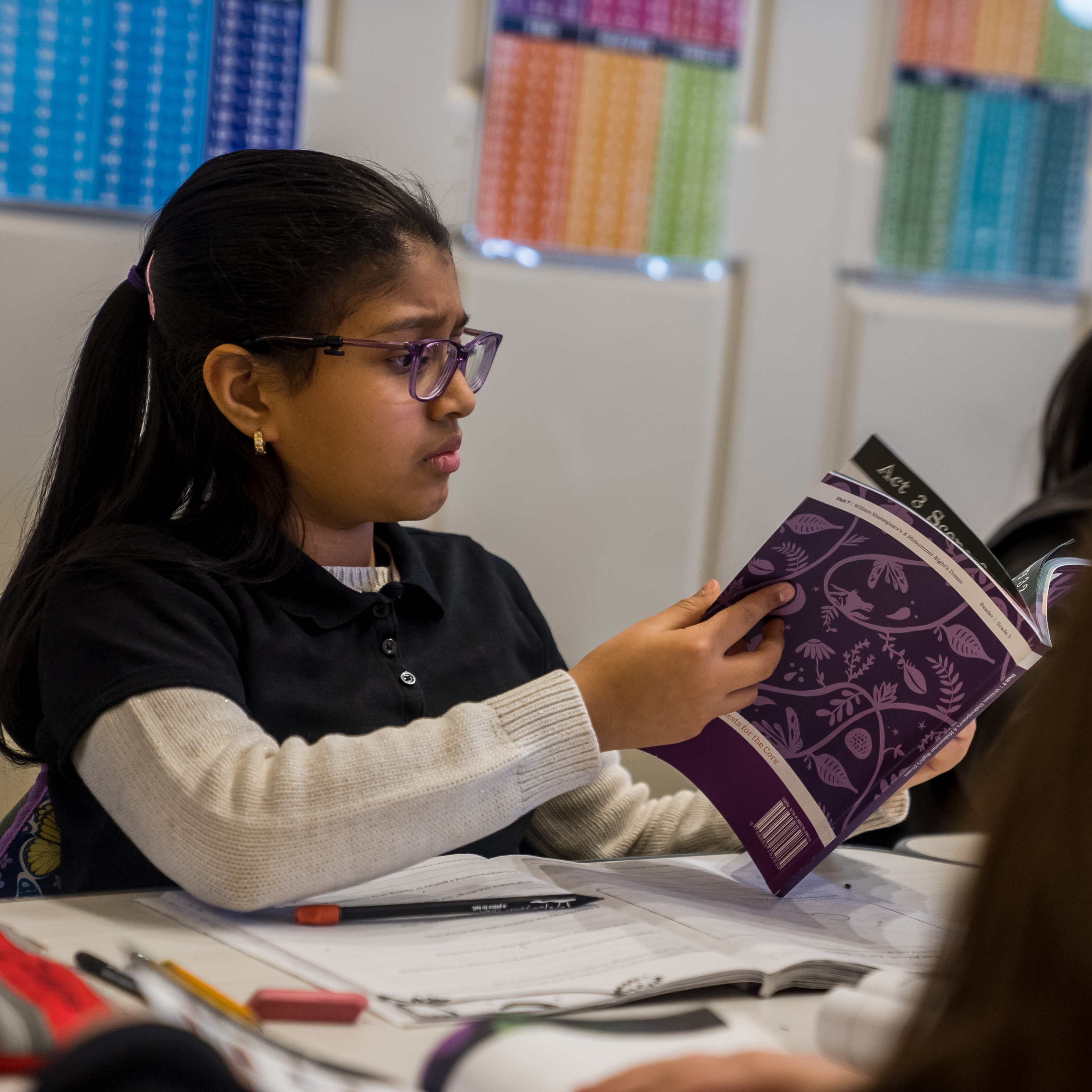 Student reading a book in class